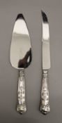 A silver handled King's pattern cake knife and cake server, hallmarked Sheffield 1966 and 1970.