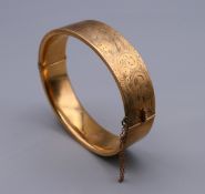 A 9 ct gold bracelet. 6.5 cm wide. 21.7 grammes.