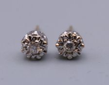 A pair of 9 ct gold diamond solitaire earrings. 5 mm diameter.