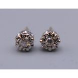 A pair of 9 ct gold diamond solitaire earrings. 5 mm diameter.