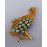 An 18 ct gold jade bird brooch. 6.5 cm high. 15.3 grammes total weight.