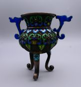 A Chinese enamel decorated silver vase. 9 cm high.