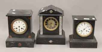 Three Victorian black slate mantel clocks. The largest 28 cm high.