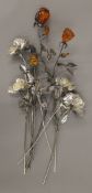 A quantity of white metal roses. The largest 42 cm high.