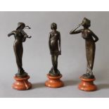 A set of three bronze Art Nouveau style girl figures. The largest 21.5 cm high.