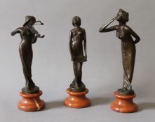 A set of three bronze Art Nouveau style girl figures. The largest 21.5 cm high.