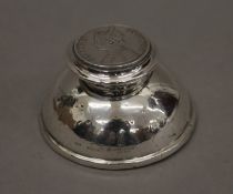 A small silver inkwell, hallmarked Birmingham 1922, the lid inset with a silver coin of Victoria,