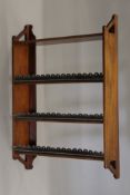 A Victorian mahogany hanging bookshelf. 61 cm wide.