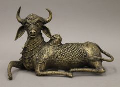 An Indian bronze model of a cow. 25 cm long.