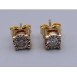 A pair of 9 ct gold diamond solitaire earrings. 5 mm diameter.