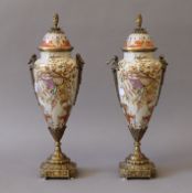 A pair of gilt metal mounted porcelain vases. 37 cm high.