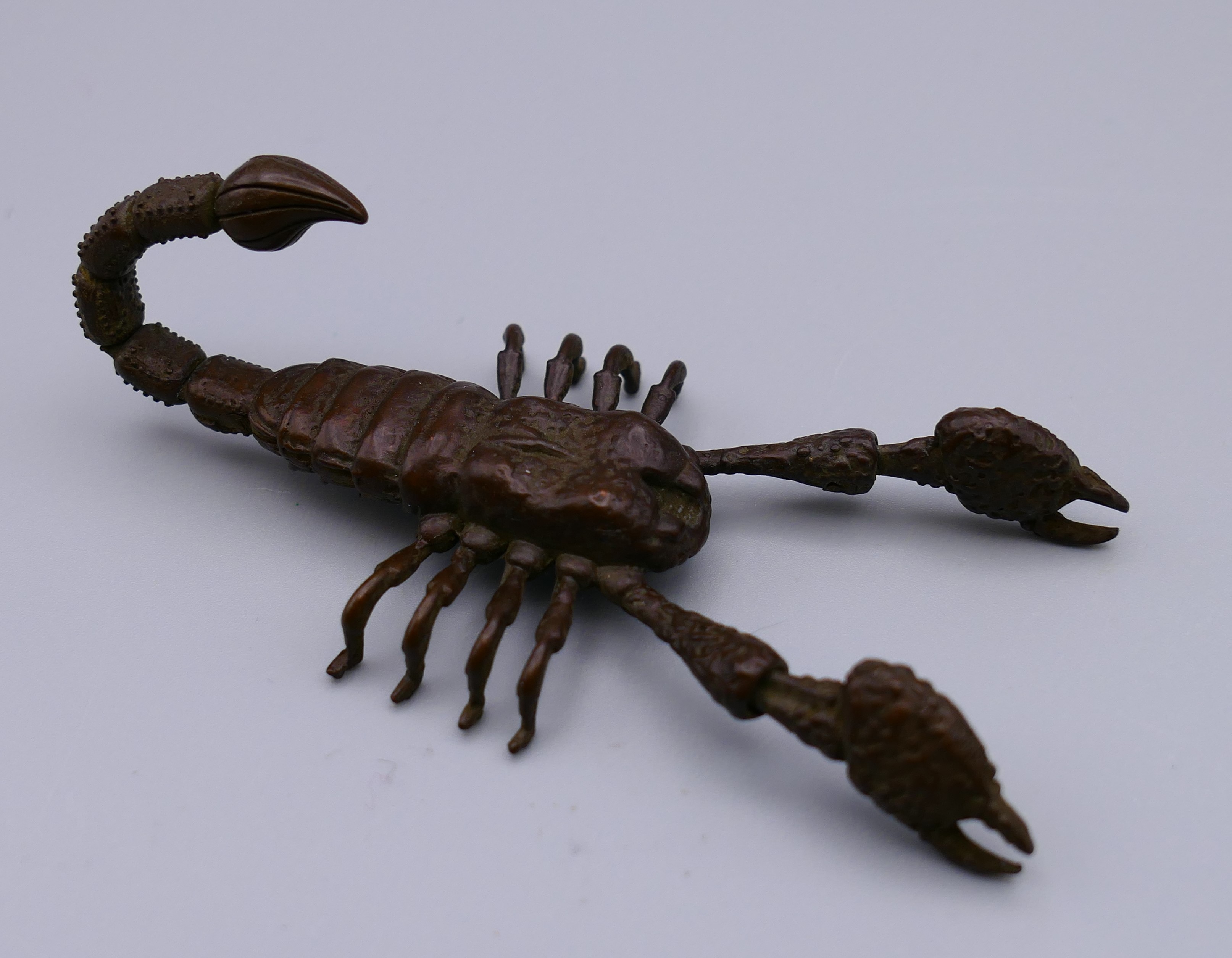 A bronze articulated model of a scorpion. 8 cm long.