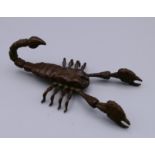 A bronze articulated model of a scorpion. 8 cm long.