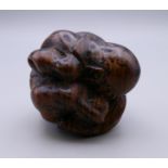A carved wooden weeping Buddha. 5 cm high.