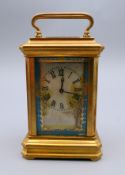 A miniature porcelain set carriage clock. 9 cm high.