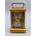 A miniature porcelain set carriage clock. 9 cm high.