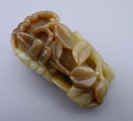 A Chinese jade floral carving. 6 cm high.