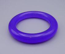 A lavender jade bangle. 8.5 cm diameter.