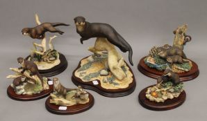 A quantity of Border Fine Arts models of otters.