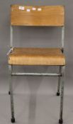 A vintage Bentwood stacking school chair. 40 cm wide.