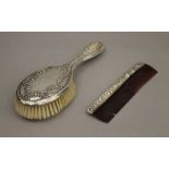 A boxed silver brush and comb set. The box 28 cm wide.