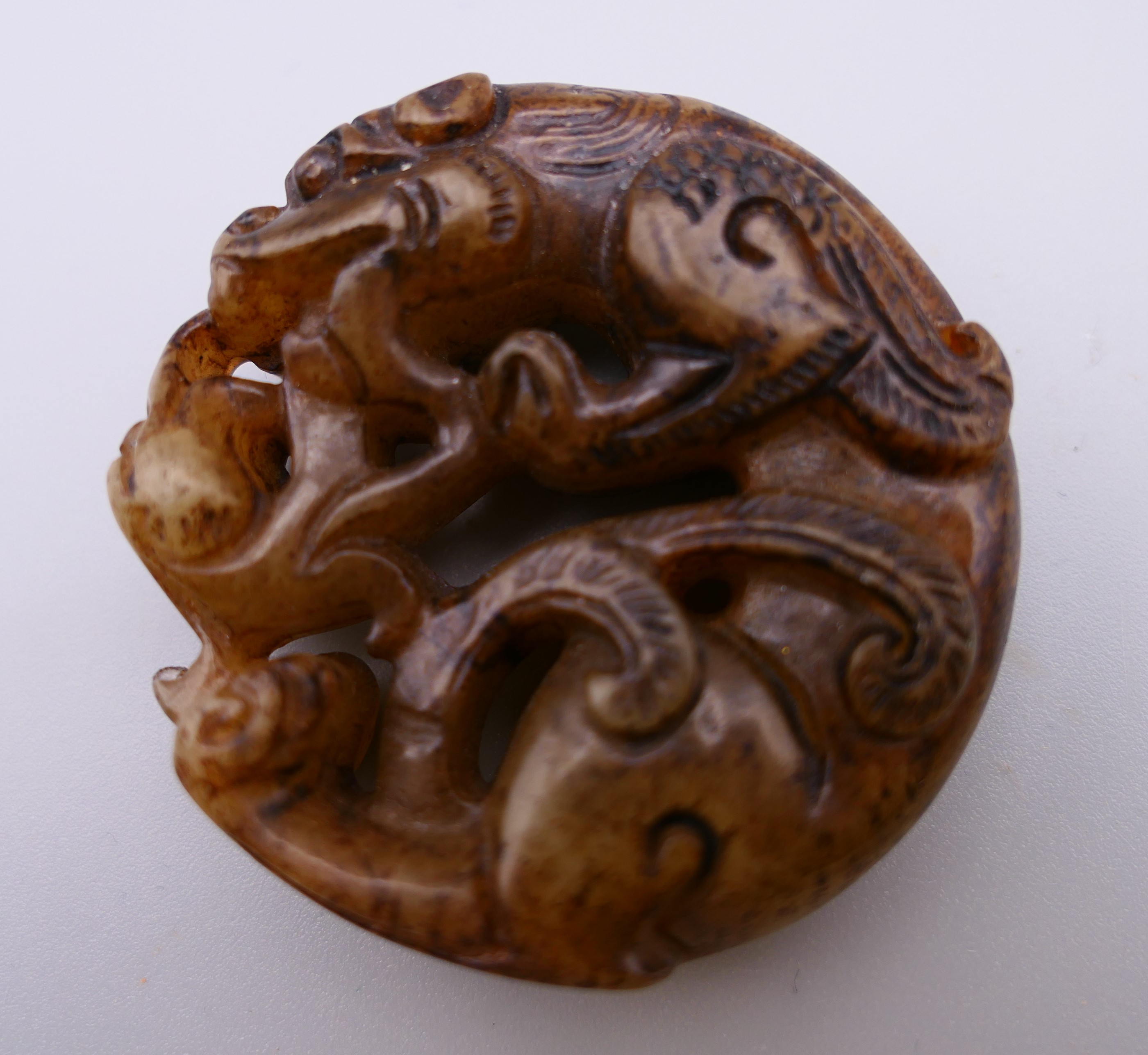 A jade roundel formed as a dragon. 4.75 cm diameter. - Image 2 of 5