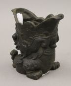 A Chinese cast metal dog-of-fo brush pot. 11.5 cm high.