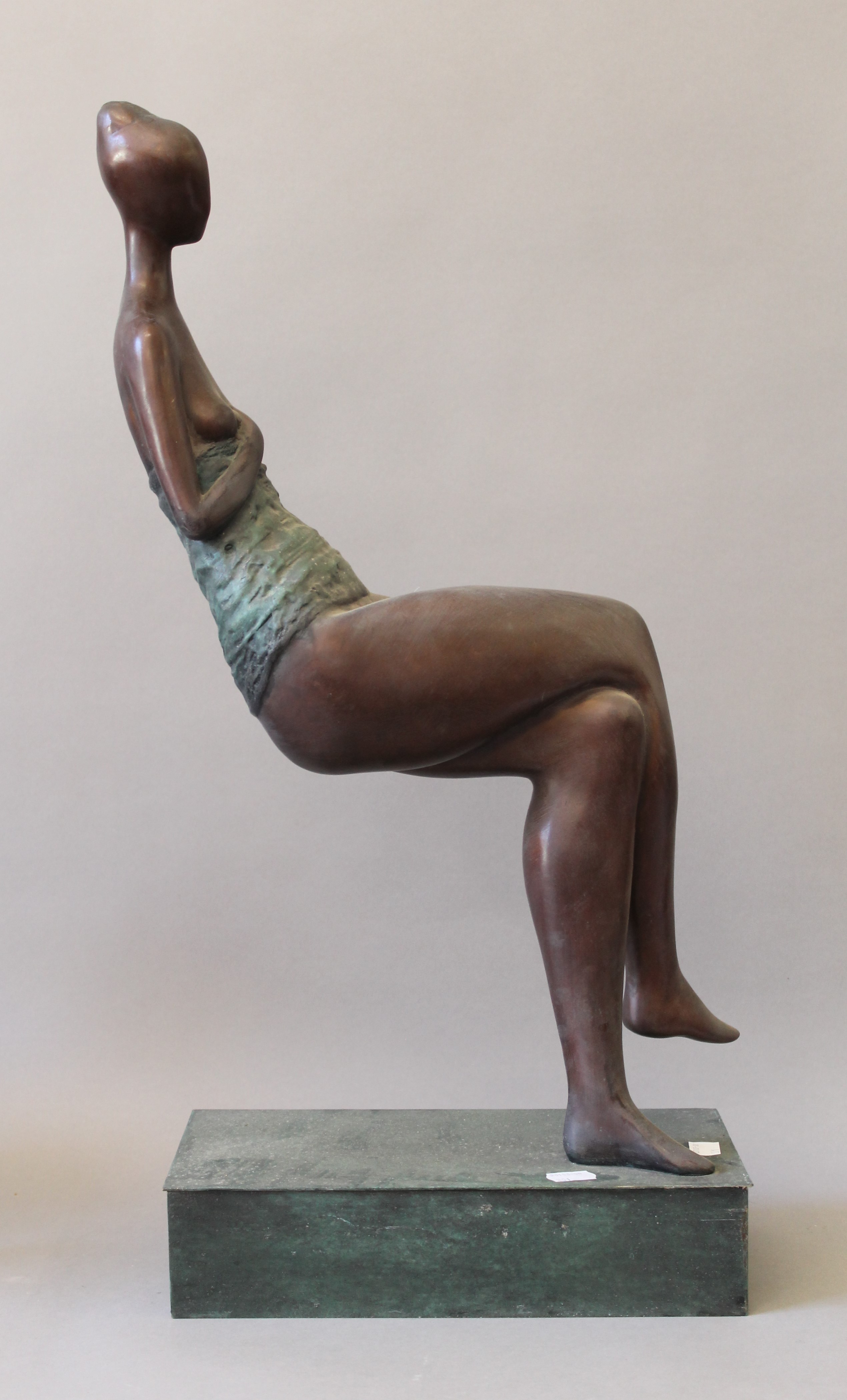An abstract bronze sculpture of a sitting woman. 62 cm high.