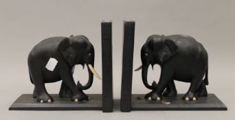 A pair of carved ebony elephant form bookends. Each 17 cm high.