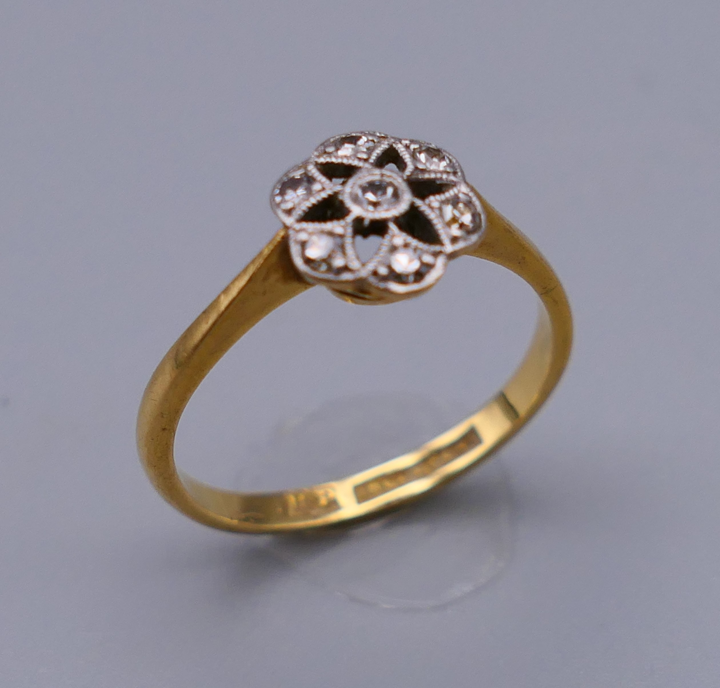 An 18 ct gold and diamond flower head ring. Ring size M. 8 mm high. - Image 3 of 8