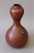 A Japanese bronze double gourd vase mounted with a frog. 20 cm high.