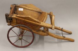 A vintage wooden model cart. 60 cm long.