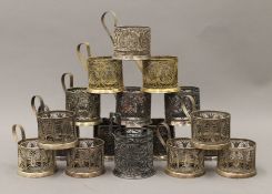 A quantity of various white metal and gilt cup holders.