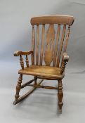 A Victorian splat back rocking chair. 53.5 cm wide.