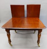 A 19th century mahogany two leaf extending dining table. 230 cm long extended x 126.5 cm wide.