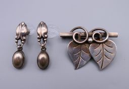 A Georg Jensen silver brooch and earrings. The brooch 4 cm wide.