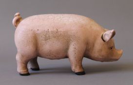 A cast iron pig money box. 18.5 cm long.