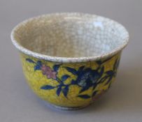 A Chinese yellow crackle glaze porcelain tea bowl. 9 cm diameter.