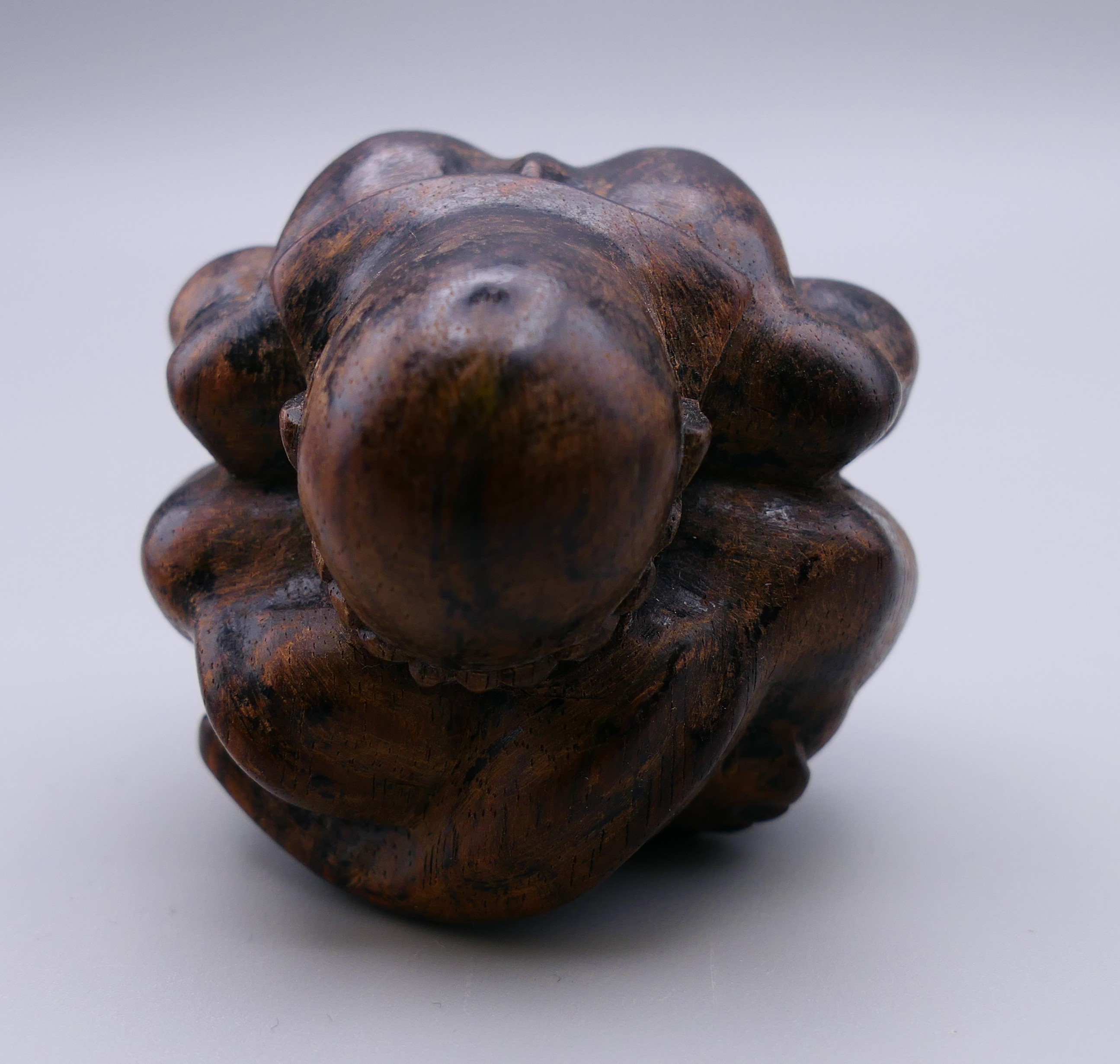 A carved wooden weeping Buddha. 5 cm high. - Image 2 of 4