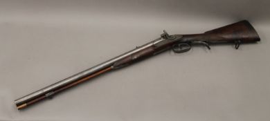 A 19th century double barrelled shotgun/rifle, inscribed 'W G Rawbone Capetown'. 95 cm long.