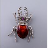 A silver enamel beetle brooch. 4.5 cm long.