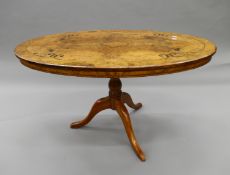 A Victorian inlaid walnut loo table, mounted on associated tripod base. 106 cm long.