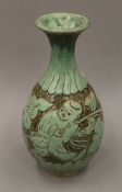 An Oriental green glazed pottery vase. 25 cm high.