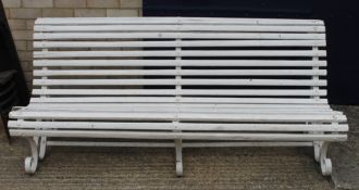 A white painted garden bench.