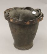 An antique leather bucket. 24 cm high.
