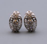 A pair of 9 ct white gold stone set earrings. 1.2 cm high. 2.7 grammes total weight.