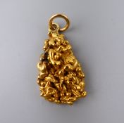 An unmarked high carat gold (probably 22 ct) nugget on a lower carat gold suspension loop. 19.
