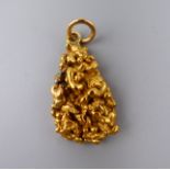 An unmarked high carat gold (probably 22 ct) nugget on a lower carat gold suspension loop. 19.