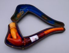 A 19th century cased meerschaum and amber pipe formed as a ladies hand. The case 18 cm long.
