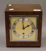 An Art Deco oak cased mantel clock. 21 cm wide.